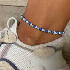 🌸 navy blue, sky blue and silver miracle bead anklet 🌸  ♥️Catches the light to give off a glow!  ♥️Perfect for nights out or even holidays!  ♥️Please message me if you have any questions each  ♥️ All anklets are made on rope. The two ends will need to be tied together and in a double knot so that the anklet does not come off. These are safe to wear in water.  Also available with matching bracelets, earrings and chokers! The colour may vary slightly due to most images being taken under direct sunlight or with flash to show you the full effect of the beads x  White beads may appear grey/silver when opened in a dark room. The full effect of the beads will shine through in different lights. Please note: Buyer pays for any return postage/ exchange postage x Navy Blue Sky, Bead Anklet, Double Knot, Beaded Anklets, Dark Room, Anklet Jewelry, Body Jewellery, Matching Bracelets, White Beads