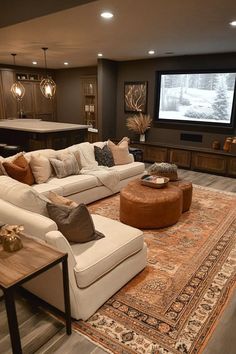 a living room filled with furniture and a flat screen tv mounted to the side of a wall