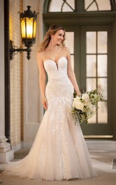 a woman in a wedding dress holding a bouquet