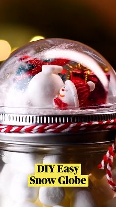 a glass jar filled with snowballs and candy canes on top of a table