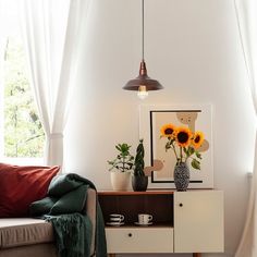 a living room with a couch, table and flowers in vases on top of it