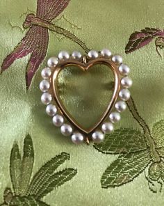 "A 14K Heart brooch-yellow gold with 20 lovely lustrous white (4.5mm) cul. pearls.  The condition is great I see no problems, safety catch works marked 14K.  Clean quality Mid Century design-picture show details.  Size 1 1/2\" by 1 1/4\", weight 6.2 grams-substantial. The heart sentimental and always soulful.  Outline of luminous pearls with graceful gold inner frame, well designed and easy to wear." Antique Heart Brooch For Wedding, Antique Heart-shaped Wedding Brooch, Elegant Heart-shaped Wedding Brooch, Elegant Brooch For Valentine's Day, Elegant Valentine's Day Brooch Jewelry, Elegant Valentine's Day Brooch, Elegant Heart Shaped Brooch Jewelry, Gold Heart-shaped Brooch For Formal Occasions, Gold Heart Brooch For Formal Occasions