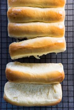 four loaves of bread sitting on top of a cooling rack