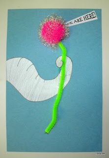 an art project made out of paper and yarn with a pink pom - pom