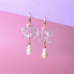 The Daisy Pearl Drops are elegant floral earrings that add a touch of class and polish to any outfit. Perfect for a fancy affair (wedding! date night!) or any occasion when you want to impress and glimmer! Hand-made in studio using beautiful marbled acrylic and glass pearls.  The drops hang from 18mm, 14 karat, gold-filled hoops and are removable so you can wear the hoops on their own—two earrings in one, perfect for travel! Uses 14 karat gold-filled hoops which are tarnish resistant and hypoall Feminine Flower Charm Earrings, Feminine Flower Dangle Earrings With Pearl Drop, Feminine Flower Shaped Pearl Drop Earrings, Feminine Flower Drop Earrings With Pearl Drop, Elegant Bridal Dangle Earrings With Flower Charm, Elegant Teardrop Earrings With Flower Charm, Feminine Dangle Earrings For Wedding, Feminine Dangle Earrings For Anniversary, Chic Wedding Jewelry With Flower Charm