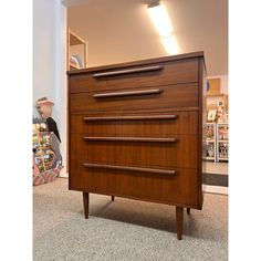 a wooden dresser sitting on top of a carpeted floor