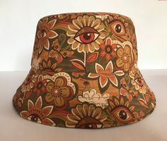 This is the Gold Flower Eye bucket hat. Perfect for those vintage festival vibes! ✌️ It is fully reversible giving you two looks in one hat.  It is made from an exclusive Stan&Gwyn print on one other side, and the reverse side is made from a plain stone cotton.  It's always best if you provide me with your exact head measurement for an accurate fit.  Otherwise please choose from the following sizes - Small - 22" Med - 23" Large - 24" XL - 25" Please note that the placement of the print will vary Flower Bucket Hat, Vintage Festival, Fisherman's Hat, Flower Hat, Flower Bucket, Brand Reputation, Hat Print, Hippie Vibes, Flower Hats