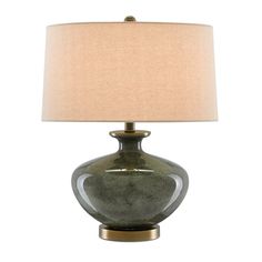 a green table lamp with a beige shade