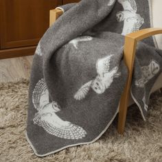 an owl blanket is draped on a chair