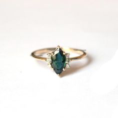 Pretty and simple Teal Sapphire diamond engagement ring. The stones can also be of other shape or kind.Gorgeous Marquise Teal Sapphire Diamond Ring, Stackable Beautiful Ring, Delicate Gemstone Ring, Wedding/Engagement Beautiful Jewelry.Product info:Main gemstone: Teal SapphireShape: Marquise Measurements: approx. 10*5 mmSide stones: white diamondsShape: roundMeasurements: approx. 1.5 mmQuality: I-J color, SI clarity, conflict-freeItem will be resized and shipped within 10 days.ITEM Will BE SHIPP Blue Marquise Engagement Ring, Marquise Gemstone Ring, Green Marquise Diamond Ring, Marquise Sapphire Wedding Ring As Birthstone, May Birthstone Sapphire Wedding Ring In Fine Jewelry, Sapphire Ring For May Birthstone, Fine Jewelry, Sapphire Wedding Ring May Birthstone Fine Jewelry, Sapphire Solitaire Ring For Wedding, Marquise May Birthstone Wedding Rings