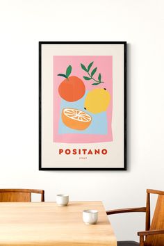 a poster hanging on the wall above a dining room table with two cups and saucers