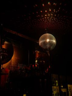 a disco ball hanging from the ceiling in a dimly lit room