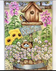 a birdhouse with flowers and birds in it