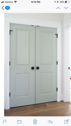 two white doors in a room with wood floors