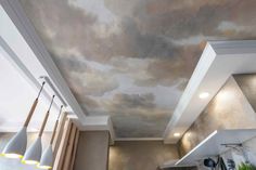 the ceiling is painted with clouds and lights