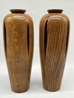 two wooden vases sitting next to each other