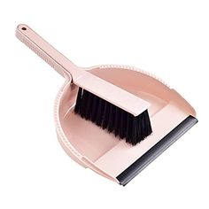 a pink dustpan with a black brush in it