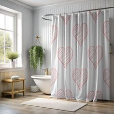 a bathroom with a white tub and shower curtain that has hearts drawn on the fabric