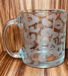 a clear glass mug with white numbers on it