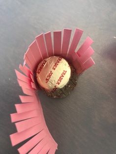 a pink cupcake wrapper sitting on top of a table