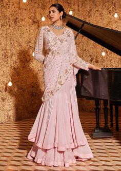 Step into elegance with this gorgeous strawberry pink drape sari in foil georgette, featuring exquisite embroidery detailing on the palla and blouse. The ensemble is paired with a pink on pink fully embroidered flattering v-neckline full sleeves blouse. Ensuring a perfect fit, the blouse is padded and equipped with a hook-eye closure on the back, adding a touch of sophistication to this stunning outfit. Drape Sari, Full Sleeves Blouse, Pink Sari, Chinese Fancy Dress, Full Sleeve Blouse, Draping Fashion, Strawberry Pink, Indo Western Dress, Embroidery Detailing