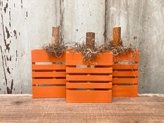 three orange wooden crates sitting on top of a table