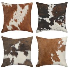 four cowhide pillows in different colors and patterns