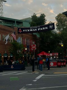 people are standing under an awning at fenway park