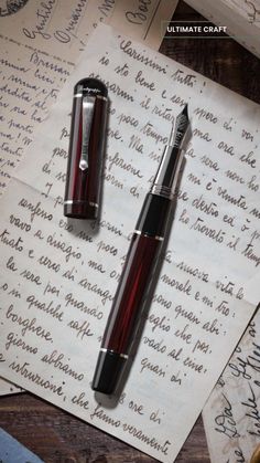 a fountain pen sitting on top of a piece of paper next to an envelope with writing