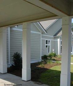 an outside view of a house with white pillars