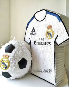 a soccer ball and shirt made out of paper