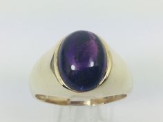 10k Yellow Gold Amethyst Ring Set With; One oval cut cabochon amethyst measuring approx. 13.6 x 10mm. February Birthstone Weight approx. 13.6g  Size 15. Amethyst - Stone of Spirituality and Contentment Bestows stability, strength, invigoration, and peace. Also known as the stone of meditation. Used to protect against psychic attacks, to encourage and support sobriety and when attempting to find freedom from addictive personalities. Also used to treat insomnia and to ameliorate pain from headache Formal Purple Cabochon Gemstones, Collectible Oval Cabochon Amethyst Ring, Formal Oval Cabochon Amethyst Ring With Polished Finish, Oval Cabochon Amethyst Ring For Formal Occasions, Oval Cabochon Amethyst Ring For Formal Events, Formal Polished Amethyst Oval Cabochon Ring, Classic Purple Cabochon Rings, Gold Oval Amethyst Cabochon Ring, Purple Oval Cabochon Hallmarked Ring