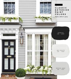 the exterior of a gray house with white trim and black door, windows, and potted plants