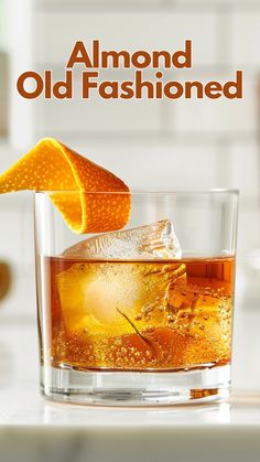 an old fashioned drink with orange peel on the rim