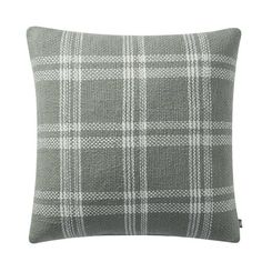 a grey and white plaid pillow on a white background