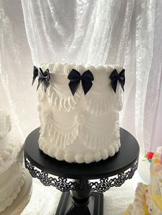 a large white cake with black bows on top