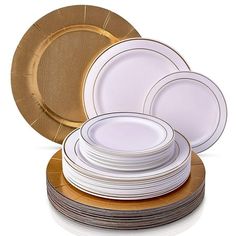 white and gold plates stacked on top of each other in front of a white background