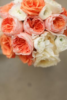 an orange and white bridal bouquet is shown