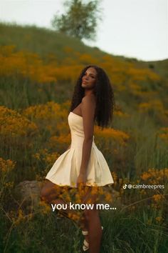 a woman in a white dress is standing in a field with yellow flowers and the words you know me