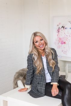 a woman sitting on top of a white table