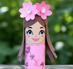 a paper doll made to look like a girl with flowers on her head and hair