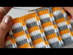 someone is crocheting the stitchs together to make a checkerboard pattern