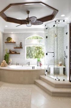 a bathroom with a large tub, sink and shower stall in it's center