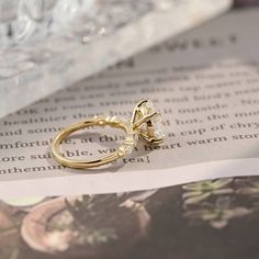 a gold ring sitting on top of an open book