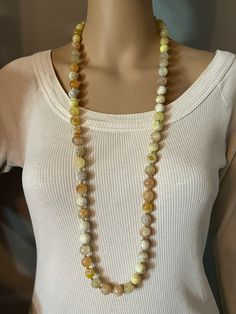 Long Fire Agate gemstone long necklace. 12 mm round faceted beads, every bead is unique in color and translucency. Gold plated spacer beads and AB rhinestone spacers.  Necklace is 38" long, antique gold toggle clasp. Can be wrapped twice around the neck. Please, keep in mind that the mannequin shown is smaller than an average person.  Ready to ship in a gift bag. Thanks for looking and have a great day! Yellow Necklaces With Natural Stones In Round Beads, Yellow Necklaces With Natural Stones And Round Beads, Yellow Necklaces With Natural Round Beads, Yellow Necklace With Faceted Beads, Yellow Necklaces With Faceted Beads, Yellow Faceted Beaded Necklaces, Yellow Faceted Beads Round Necklace, Yellow Faceted Beads Beaded Necklace, Yellow Faceted Beads Necklace