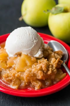 a red plate topped with apple crisp and ice cream