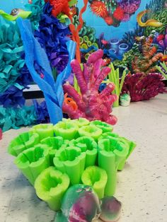 there are many different colored corals on the counter in front of some wallpaper