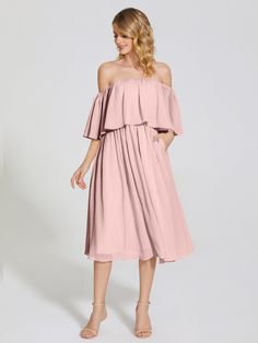 a woman is wearing a pink dress with off the shoulder sleeves and pleaed skirt