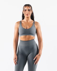 HIGHLIGHTS. Seamless construction Rib bra band for support Low to Medium impact Moisture-wicking breathable fabric Flattering scoop neckline FIT SUGGESTION. This item runs true to Alphalete's standard seamless fit.. If you are between sizes, we recommend sizing up.. Model is 5’8”/172.7cm, wearing a size M with a 36”/91.4cm bust. MATERIALS AND WASHING DIRECTIONS. 51% Polyamide, 38% Polyester, 11% Elastane. We recommend washing inside-out on a cold setting. Hang to dry DESCRIPTION With the beloved Gray Sports Bra With Built-in Bra For Pilates, Seamless Sports Bra With Wide Straps For Gym, Wide Straps Seamless Sports Bra For Gym, Supportive Gray Sports Bra With Built-in Bra, Seamless Sports Bra With Wide Straps For Workout, Medium Support Seamless Sports Bra With Wide Straps, Seamless Sports Bra With High Stretch And Wide Straps, High Stretch Seamless Sports Bra With Wide Straps, Seamless Activewear With Wide Straps For Gym