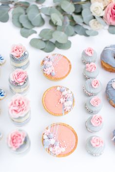 there are many decorated cookies and pastries on the table